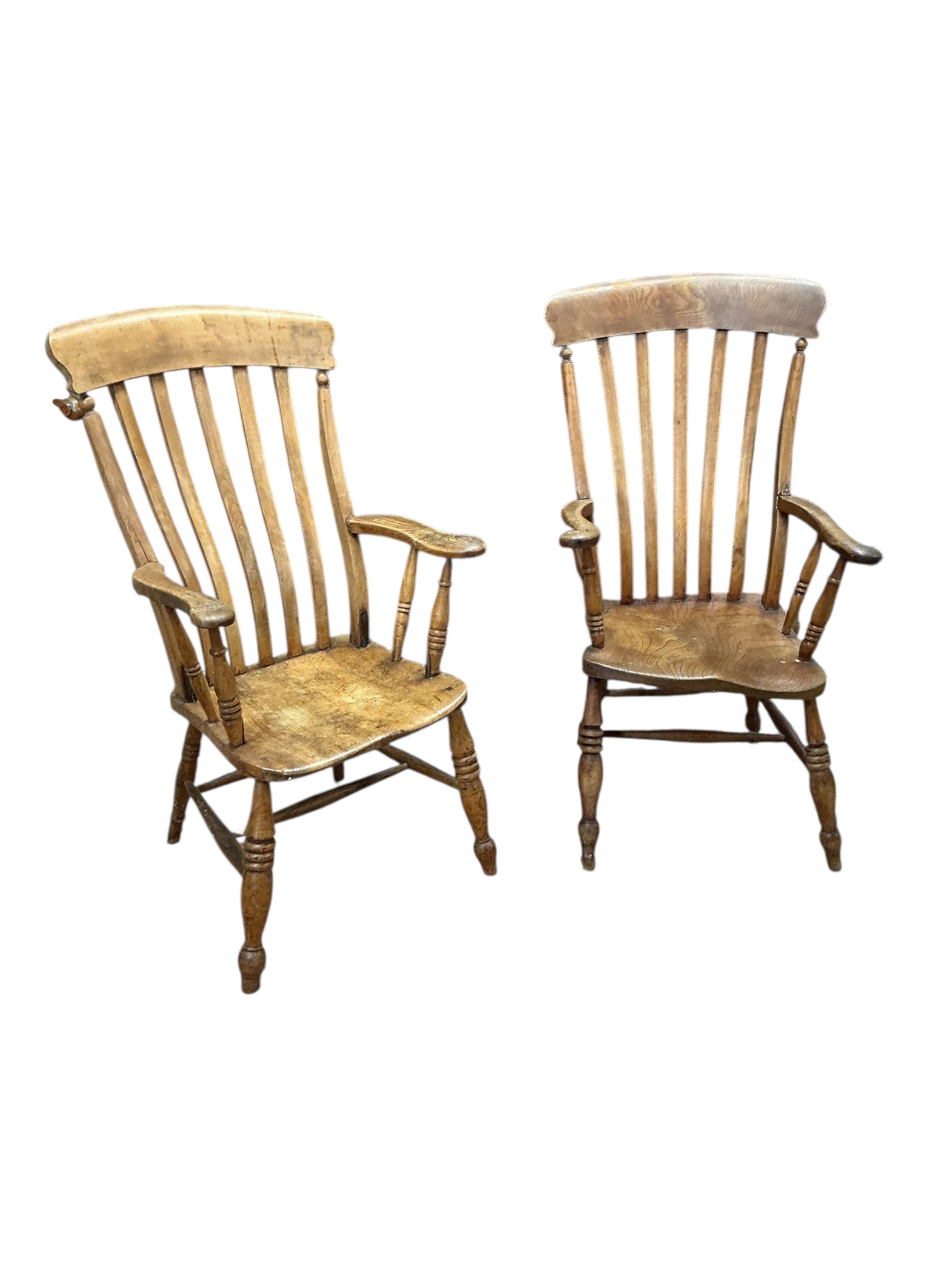 A near pair of Victorian elm and beech Windsor lathe back armchairs